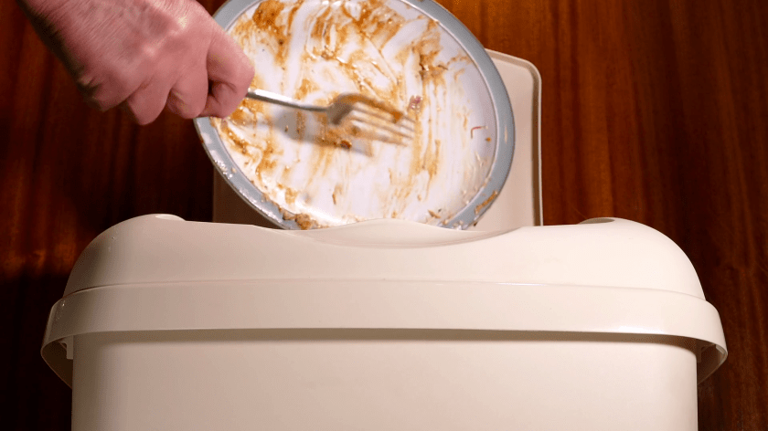 scraping garbage into wastebasket.png