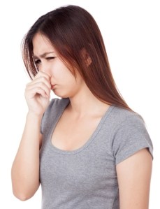 Young Asian woman  holding her nose because of a bad smell